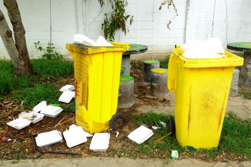 Sorted recycling bins showing glass, paper and textiles during a house clearance